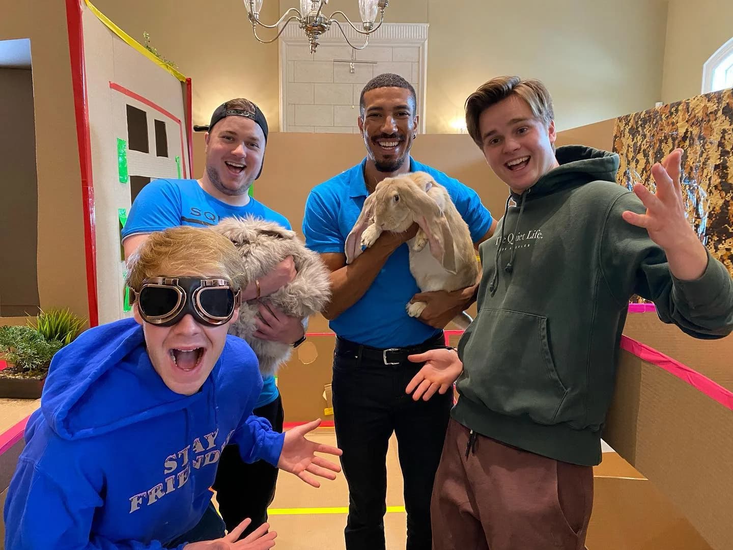 Corporate team-building group laughing together as a Hands On Exotics handler holds a rabbit